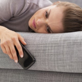 Stressed young woman with cell phone laying on couch